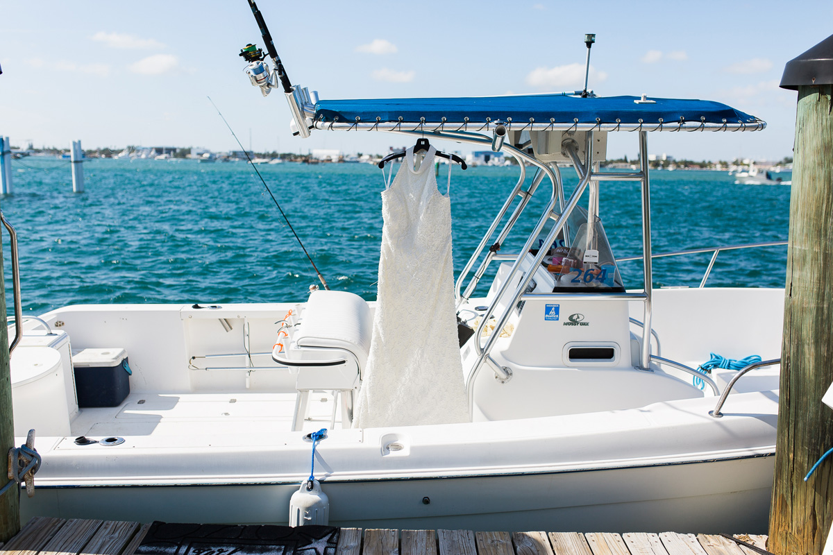 Elegant Waterfront Wedding with the Wedding Dress Hanging from a Boat | The Majestic Vision Wedding Planning | Sailfish Marina in Palm Beach, FL | www.themajesticvision.com | Chris Kruger Photography