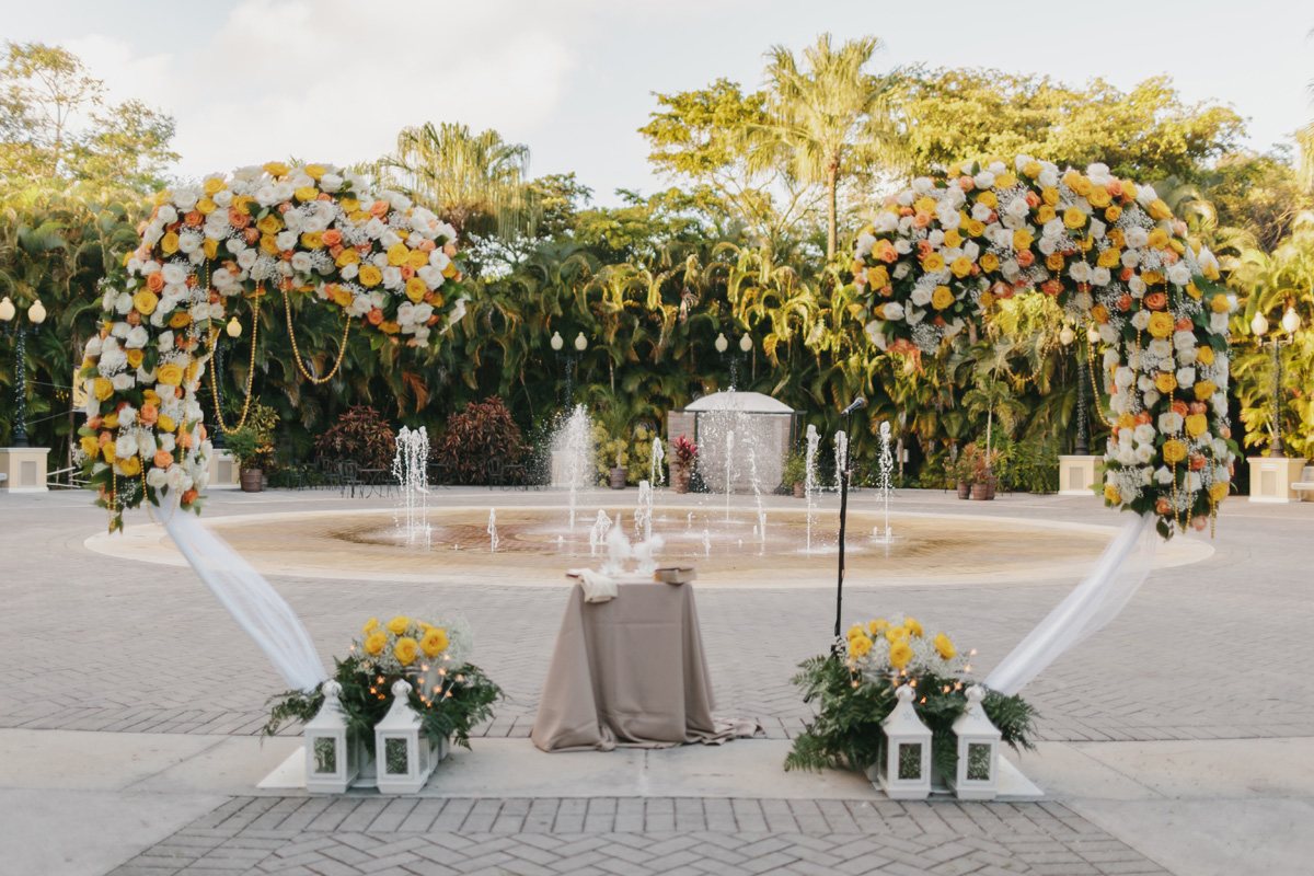 Heart Shaped Ceremony Arch Covered in Orange, Yellow and White Roses | The Majestic Vision Wedding Planning | Palm Beach Zoo in Palm Beach, FL | www.themajesticvision.com | Robert Madrid Photography